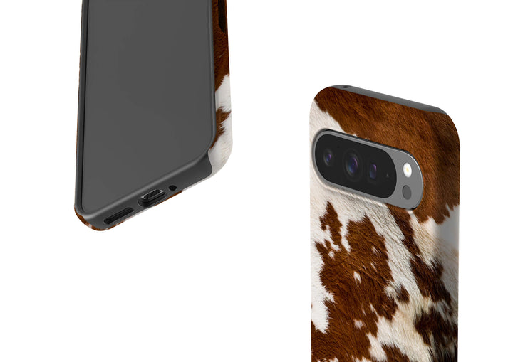 A stylish Google Tough Phone case adorned with a classic cow print pattern, perfect for animal print enthusiasts.