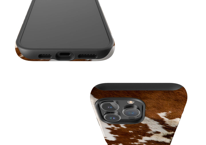 A stylish iPhone Magsafe Tough case with a brown and white cow print, perfect for those seeking a fun and unique accessory.