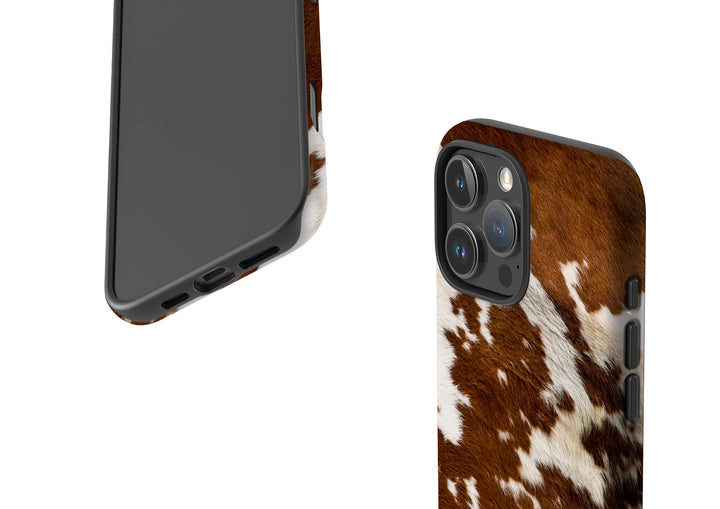 A stylish iPhone Magsafe Tough case with a brown and white cow print, perfect for those seeking a fun and unique accessory.