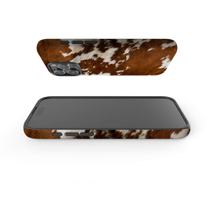 A stylish iPhone Magsafe Tough case with a brown and white cow print, perfect for those seeking a fun and unique accessory.