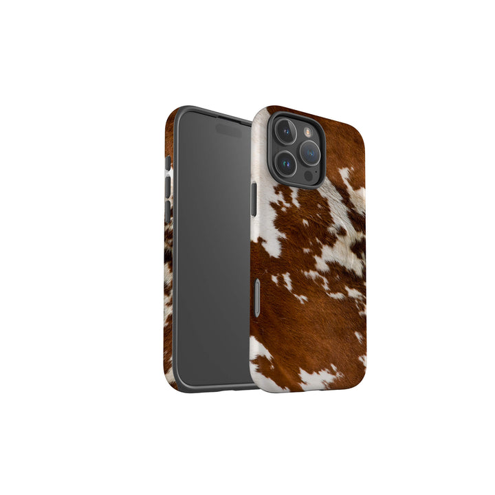 A stylish iPhone Magsafe Tough case with a brown and white cow print, perfect for those seeking a fun and unique accessory.