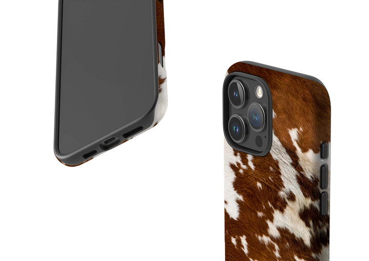 A brown and white cow print case designed for the iPhone, showcasing a unique and stylish pattern.
