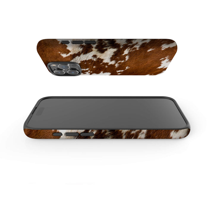 A brown and white cow print case designed for the iPhone, showcasing a unique and stylish pattern.