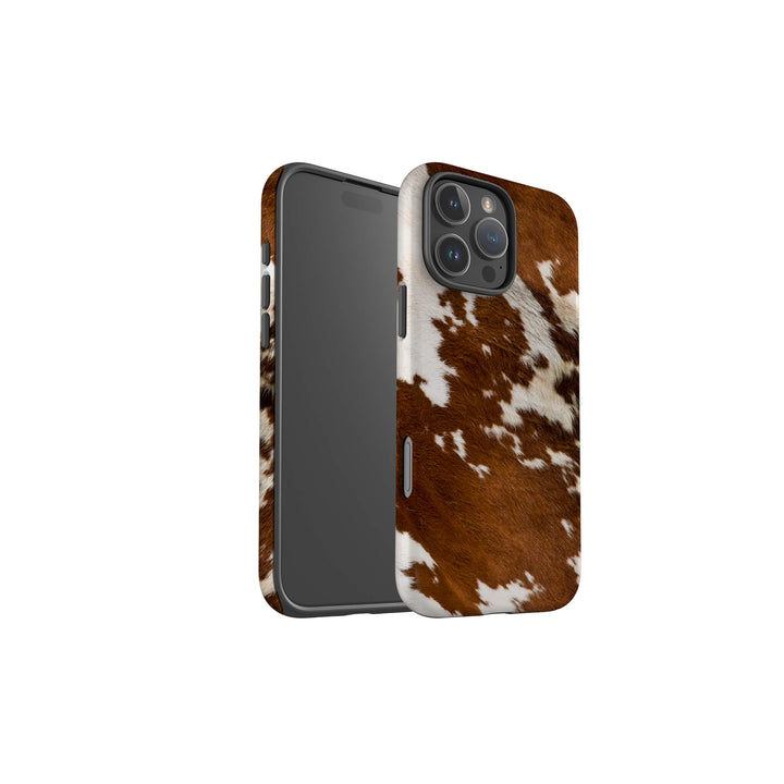 A brown and white cow print tough case designed for the iPhone, showcasing a unique and stylish pattern.